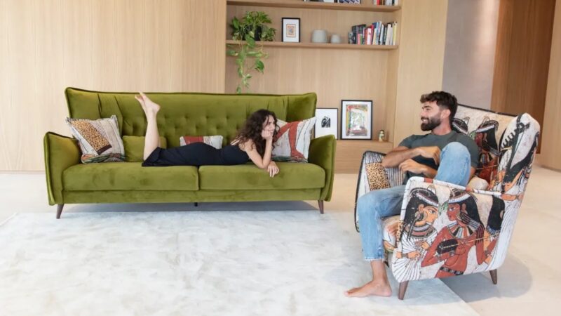 Green velvet sofa and upholstered armchair