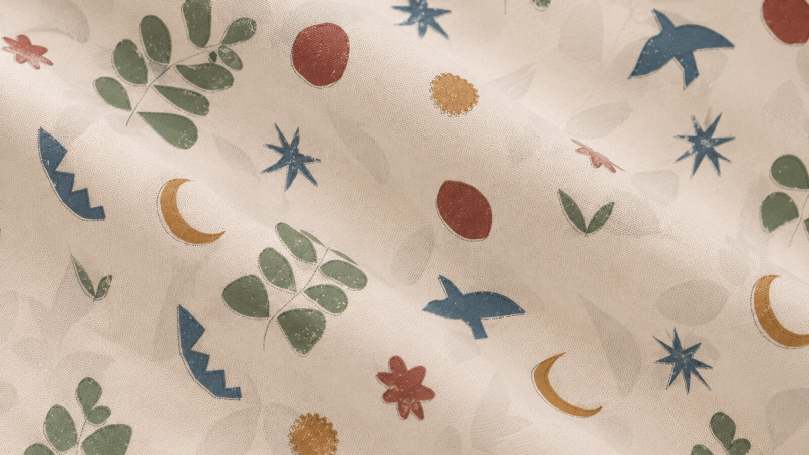 Patterned fabric with blue stars, orange crescents, red flowers, and green leaves on a cream background.