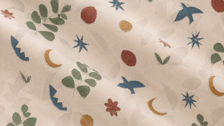 Patterned fabric with blue stars, orange crescents, red flowers, and green leaves on a cream background.