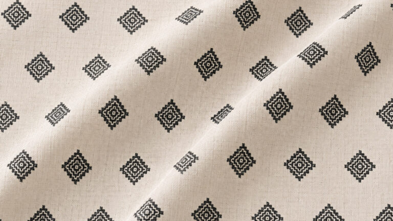Beige fabric with a repeating black diamond pattern across the surface.