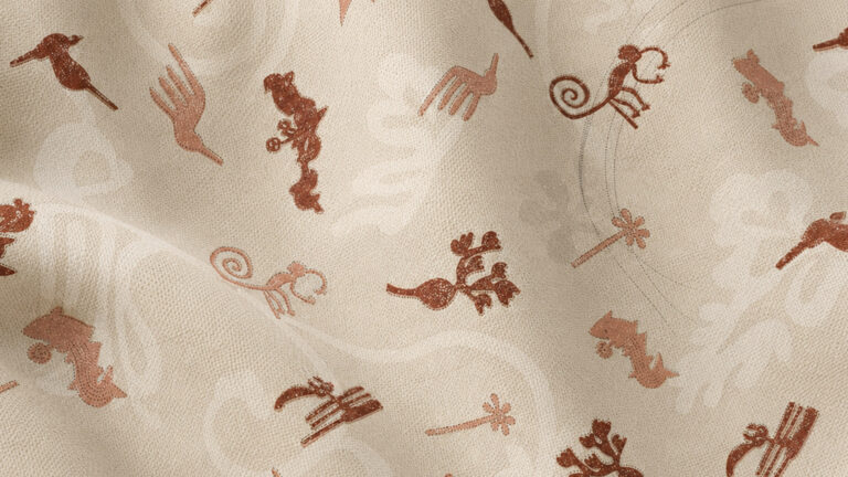 Beige textured fabric with scattered reddish-brown ornamental silhouettes and scroll motifs.