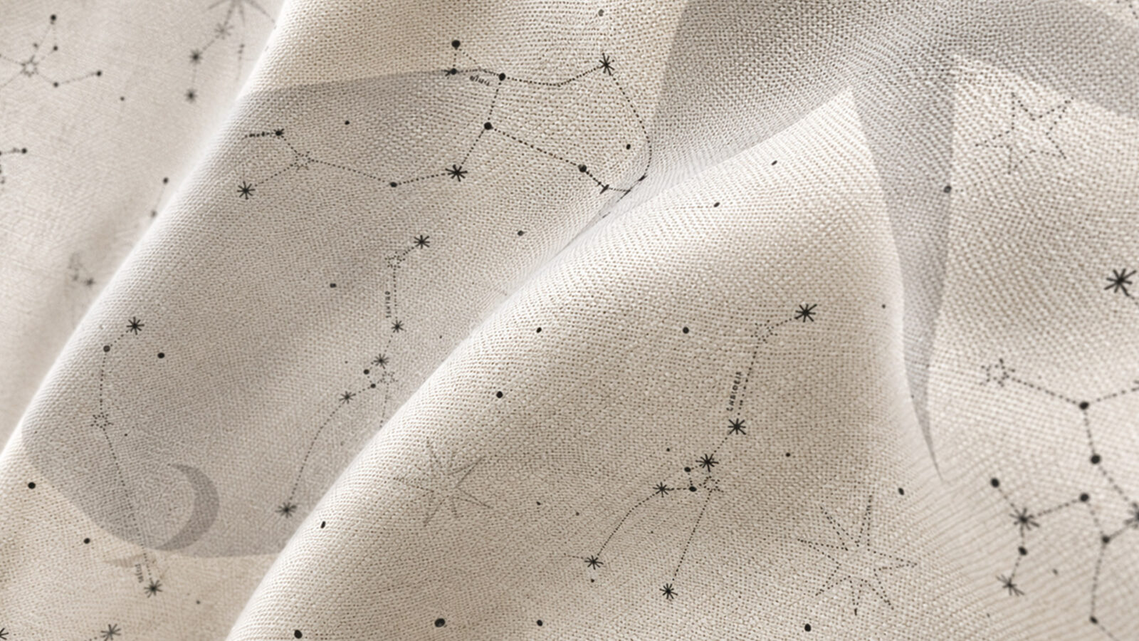 Beige fabric printed with a delicate black constellation map of stars and connecting lines, softly draped to show folds.