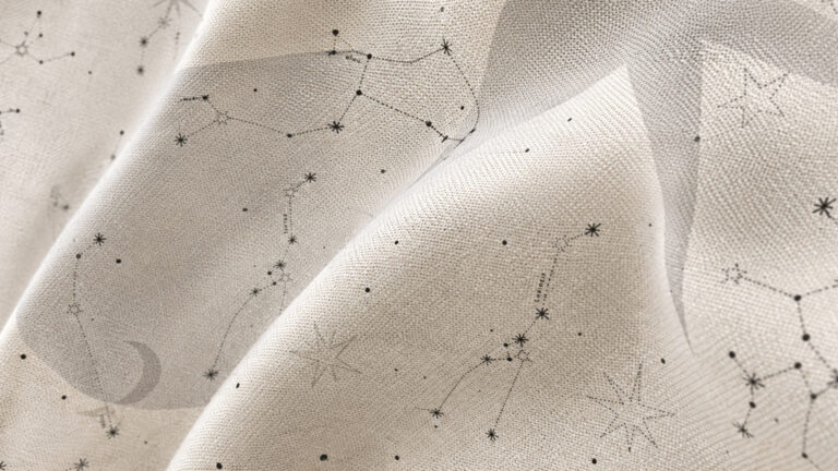 Beige fabric printed with a delicate black constellation map of stars and connecting lines, softly draped to show folds.
